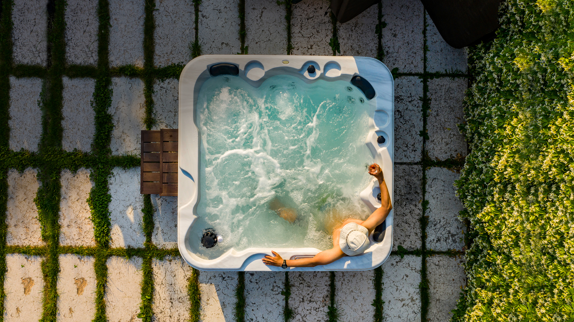 Man sitting inside an outdoor whirlpool
